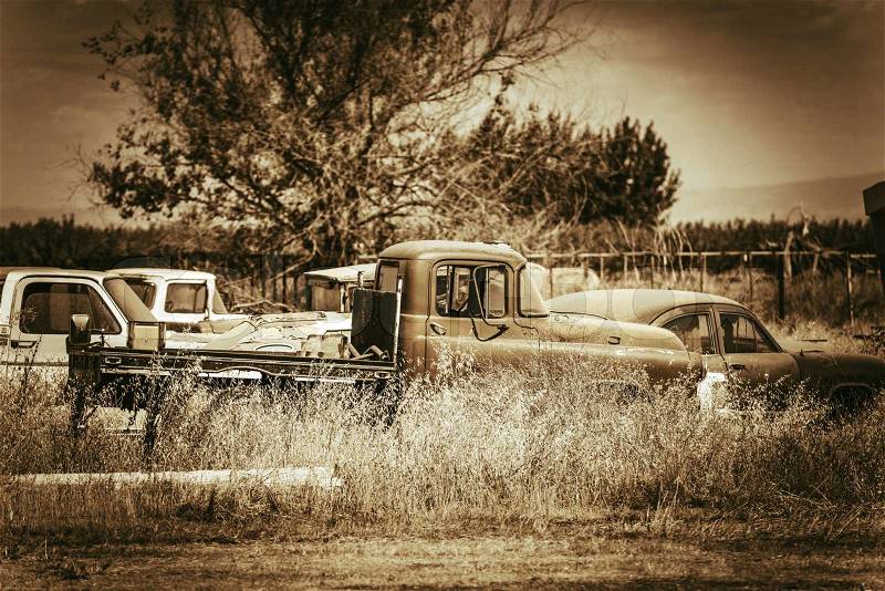 Aged American Cars Graveyard Somewhere in California. Rusty Abandoned Cars. Sepia Color Grading, stock photo