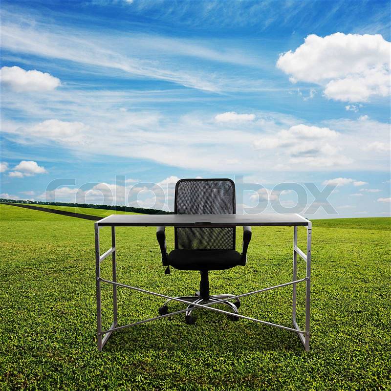 Black table and chair on the meadow, stock photo