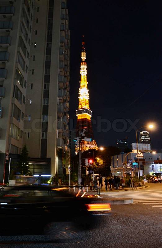 Tokyo, Japan - November 28, 2013: View of busy street at night with Tokyo Tower in the distance in Tokyo, Japan on November 28, 2013, stock photo
