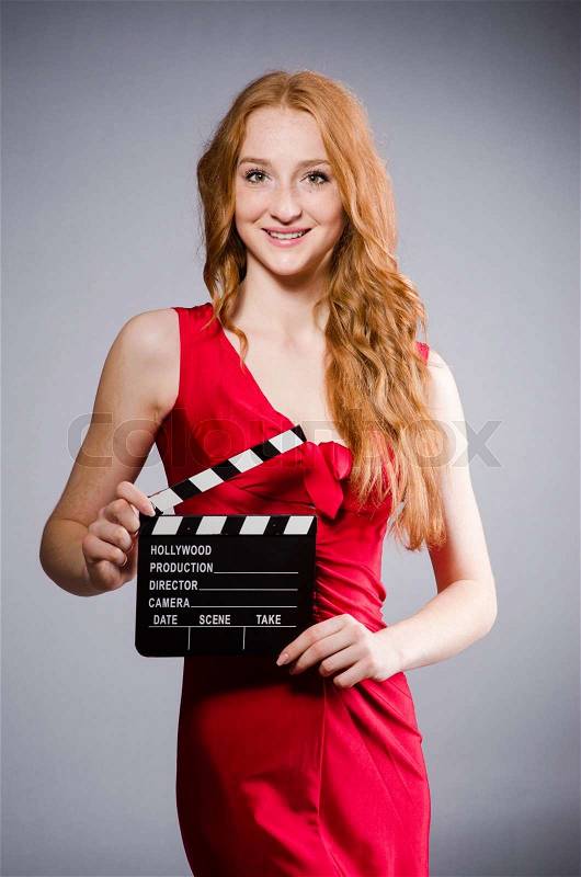Woman in red dress with movie board, stock photo