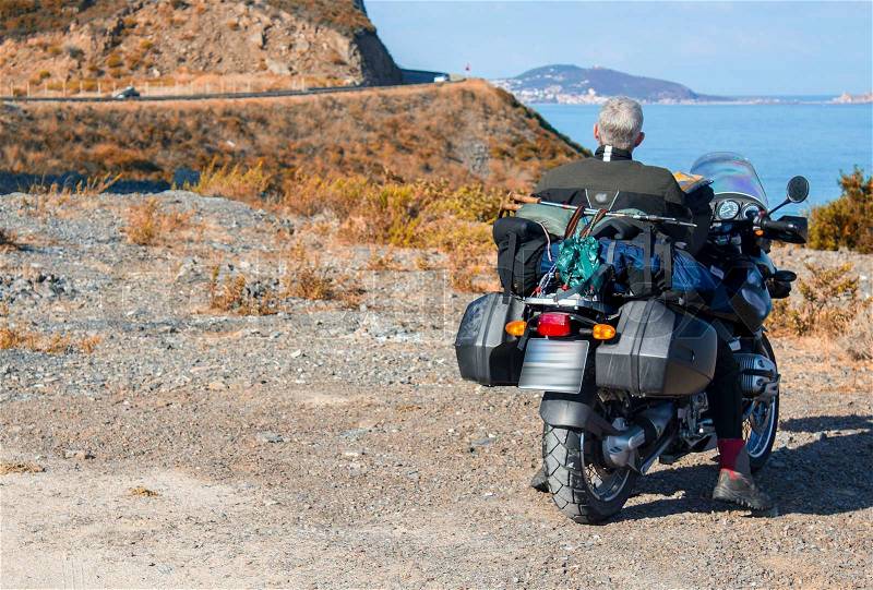 Motorbike travel and adventure on the shore of beautiful coast, stock photo