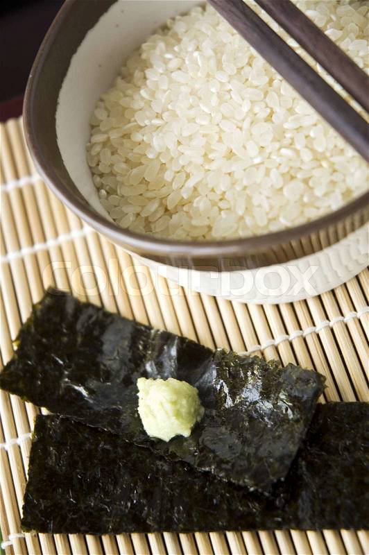 Close up uncooked japanese rice and wasabi on seaweed, stock photo