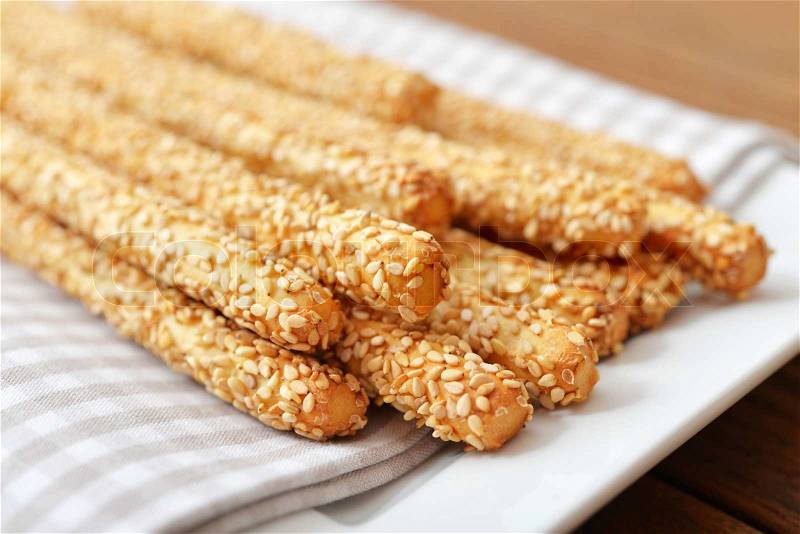 Bread sticks with sesame seeds on plate closeup , stock photo