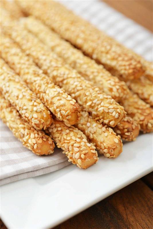Bread sticks with sesame seeds on plate closeup, stock photo