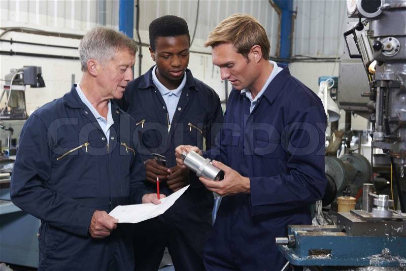 Team Of Engineers Having Discussion In Factory, stock photo