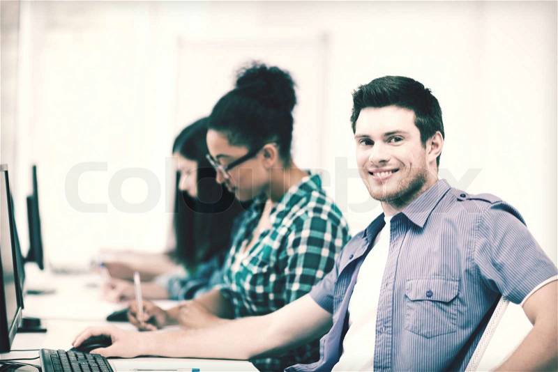 Education concept - student with computer studying at school, stock photo