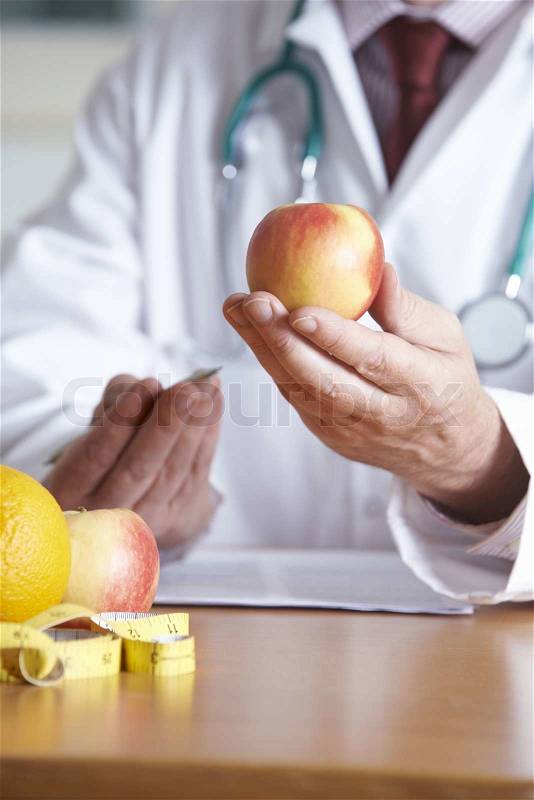 Doctor Giving Advice On Healthy Diet, stock photo