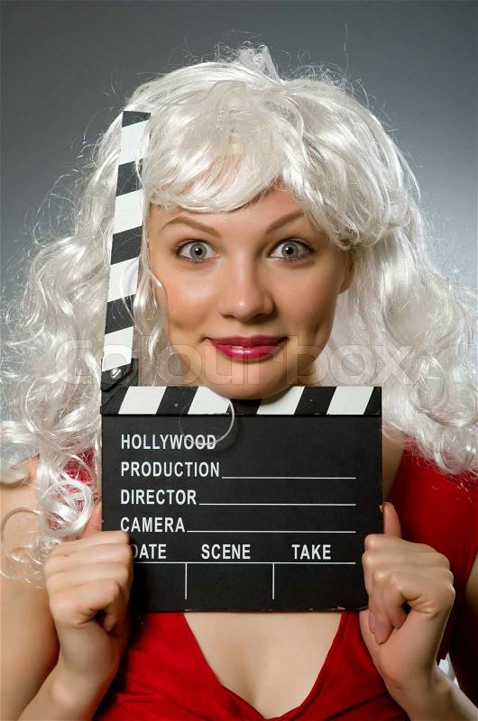 Blond woman with movie board, stock photo