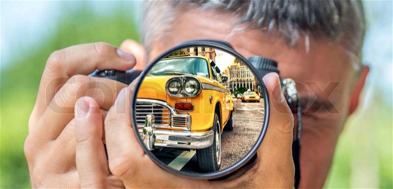 Photographer taking photo with DSLR camera at New york old taxi cab. Shallow DOF, stock photo