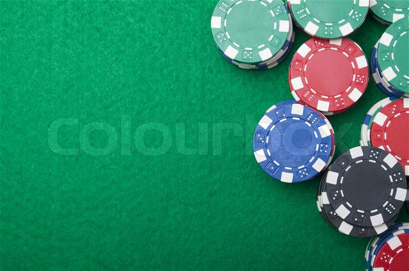 Background formed for casino chips on a green felt, stock photo