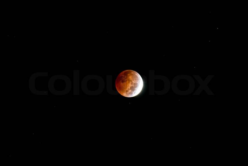 Blood Moon. Lunar eclipse as seen in the night sky on October 7, 2014. Kentucky, USA. Some background stars are seen, stock photo