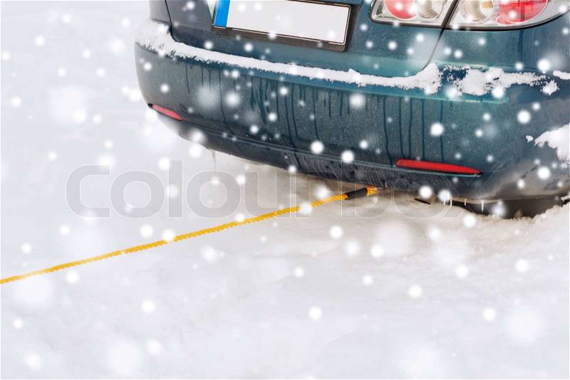 Transportation, winter and vehicle concept - closeup of towed car with towing rope, stock photo