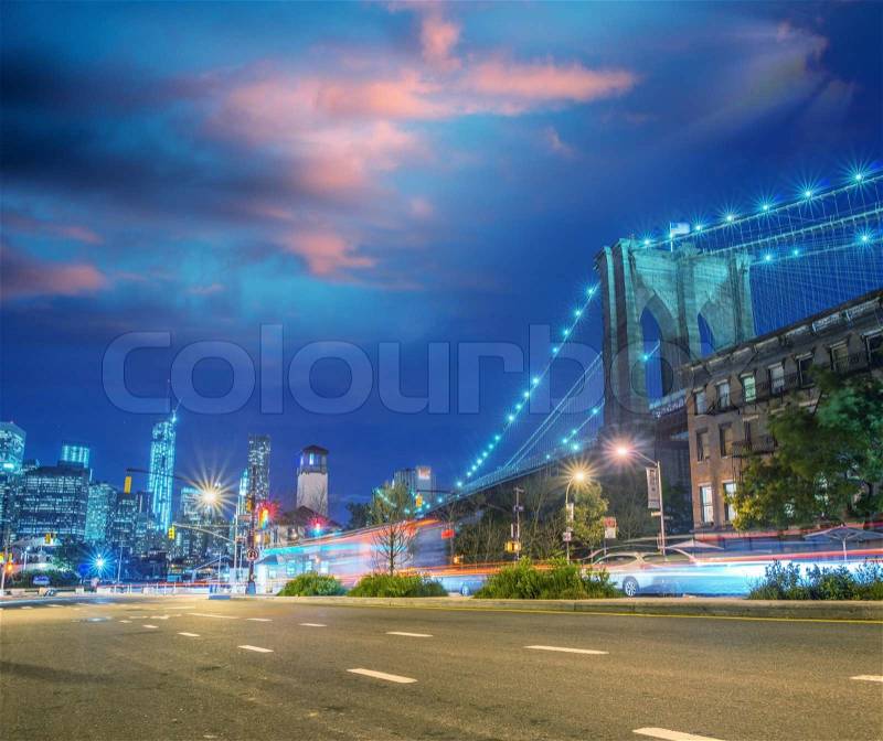 Brooklyn Bridge and Manhattan night skyline as seen from Brooklyn streets, stock photo