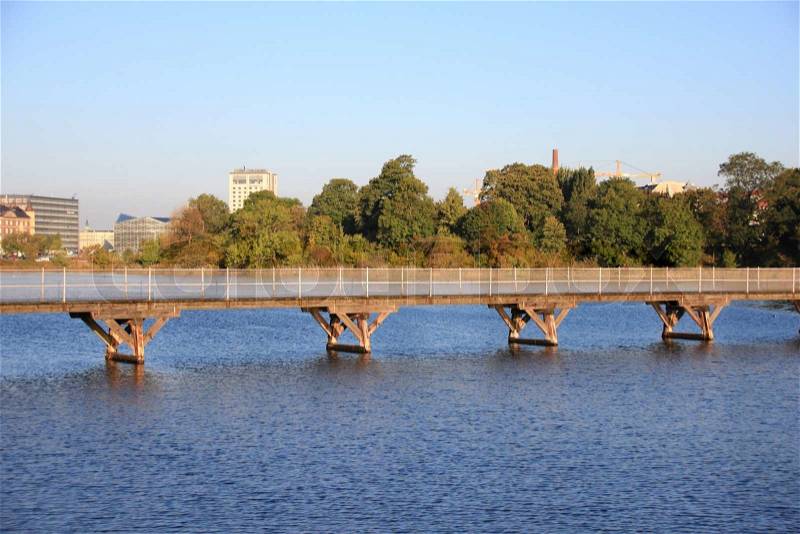 Bridge over blue water in city lake, stock photo