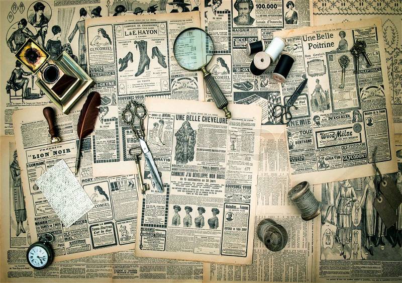 Antique accessories, sewing and writing tools, vintage fashion newspaper for the woman with advertising. retro style toned picture, stock photo