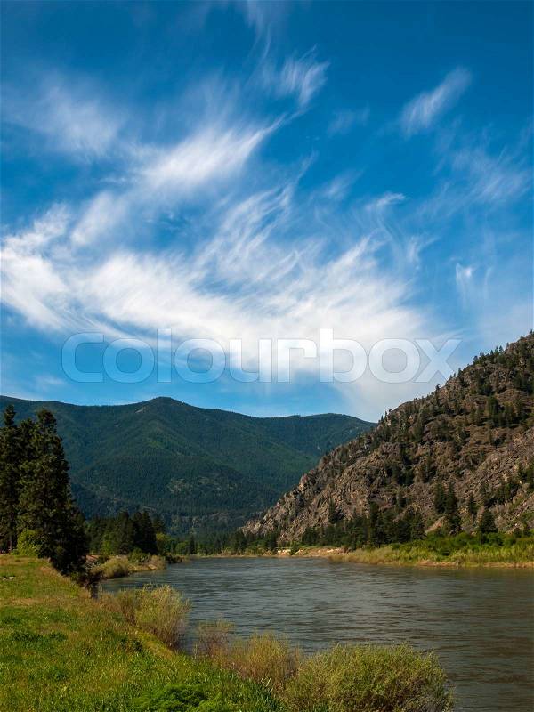 Wide Mountain River Cuts a Valley - Clark Fork River Montana USA, stock photo