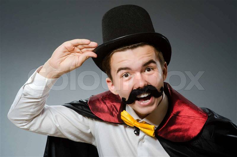 Funny magician with wand and hat, stock photo