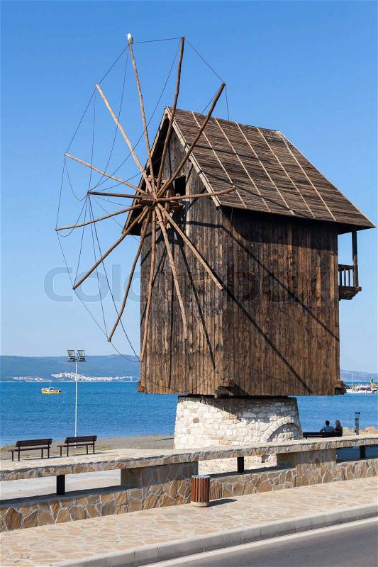 Old wooden windmill on the sea coast, the most popular landmark of old Nesebar town, Bulgaria, stock photo