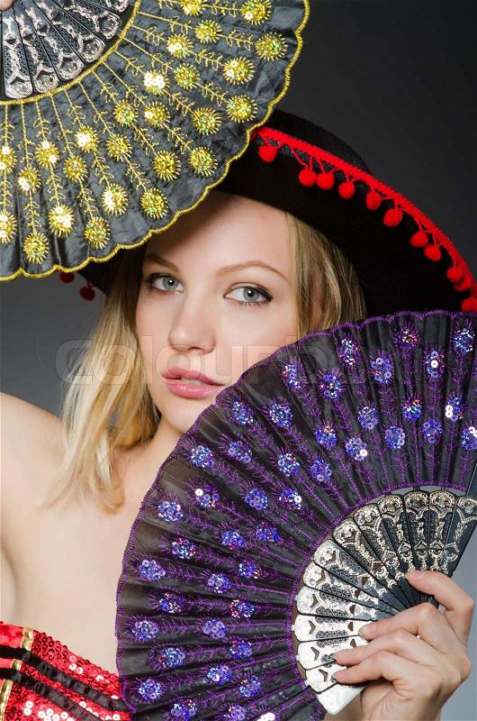 Woman dancing with fans in arts concept, stock photo