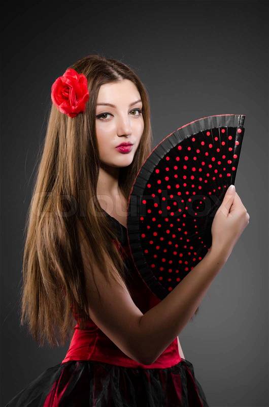 Beautiful young woman with flower and fan, stock photo