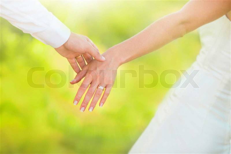 Hands of married man and woman, stock photo