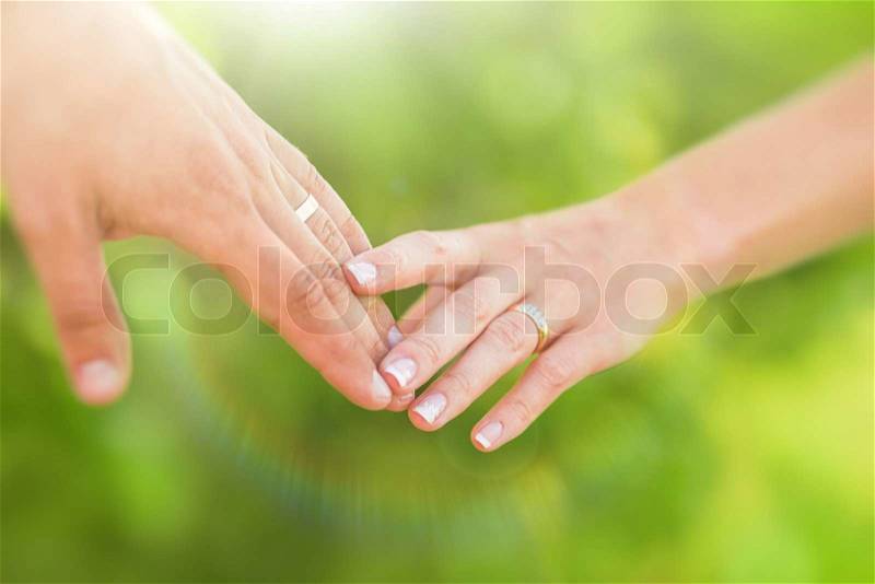 Hands of married man and woman, stock photo