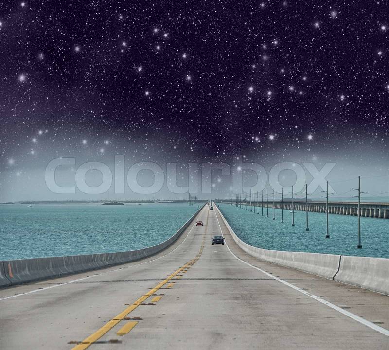 Infinite road to the ocean with stars in the night, stock photo