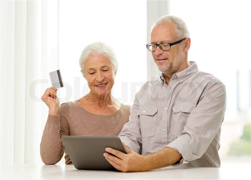 Family, technology, age and people concept - happy senior couple with tablet pc computer and credit card at home, stock photo