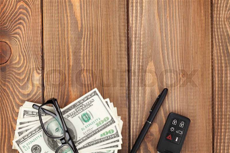 Money, glasses and car key on wooden table. View from above with copy space, stock photo