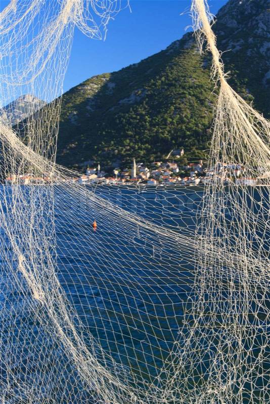 Beautiful view of the Bay of Kotor through the fishing net. vertical, Montenegro\, stock photo