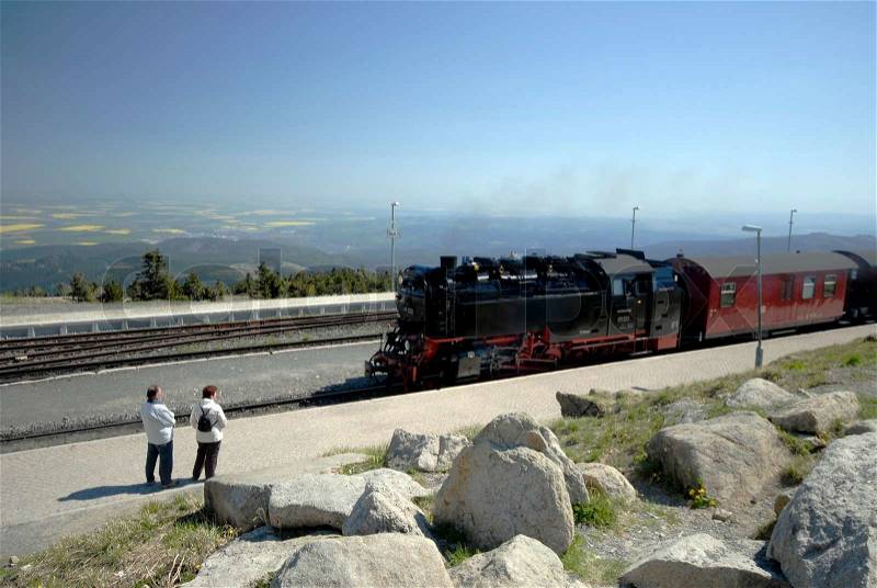 People and steam train on Brocken in Harz, stock photo