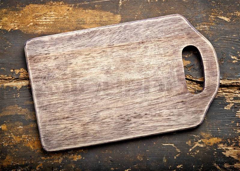 Old wooden cutting board, top view, stock photo
