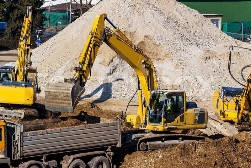 Excavator on a construction site. bucket with soil, ground work, stock photo