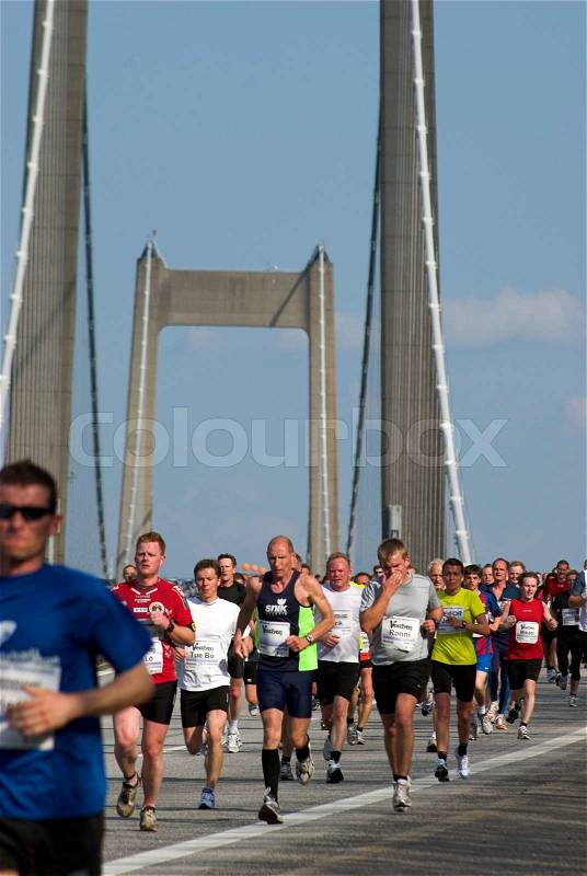 Marathon runners on The Little Belt Bridge, stock photo
