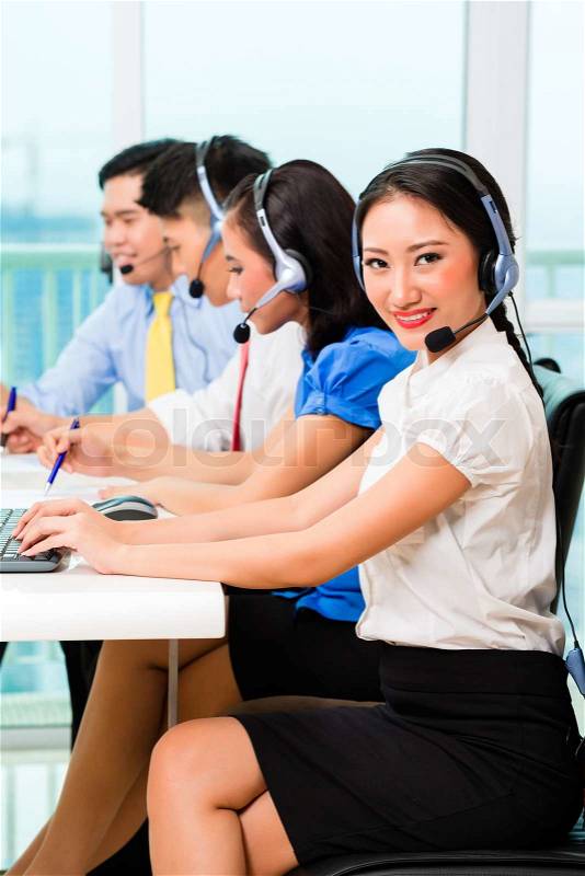 Asian Chinese call center agent team on phone, stock photo