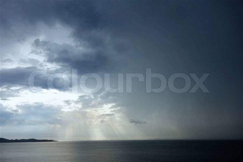 Rainy sky with sun beams, stock photo