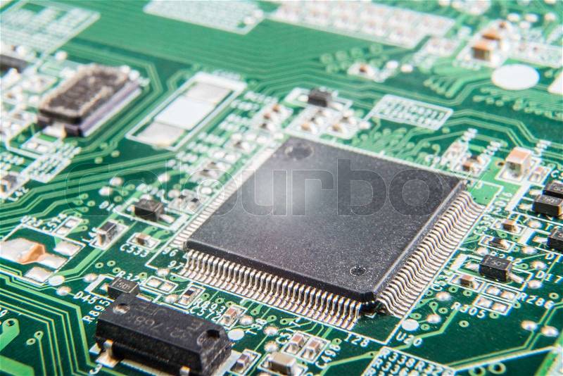 A green circuit board, solderings and paths, stock photo