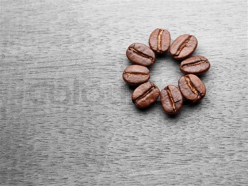 Coffee crop beans with text paper on wood texture, stock photo