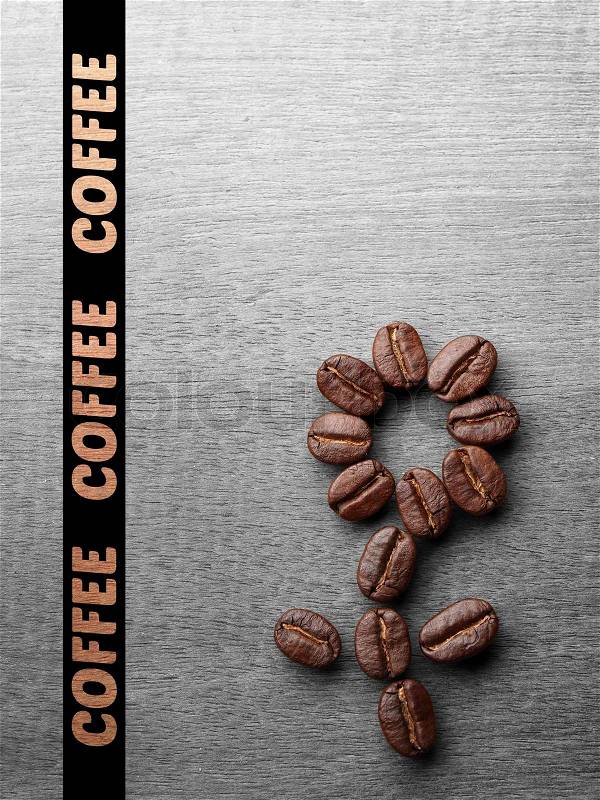 Coffee crop beans on wood texture background, stock photo