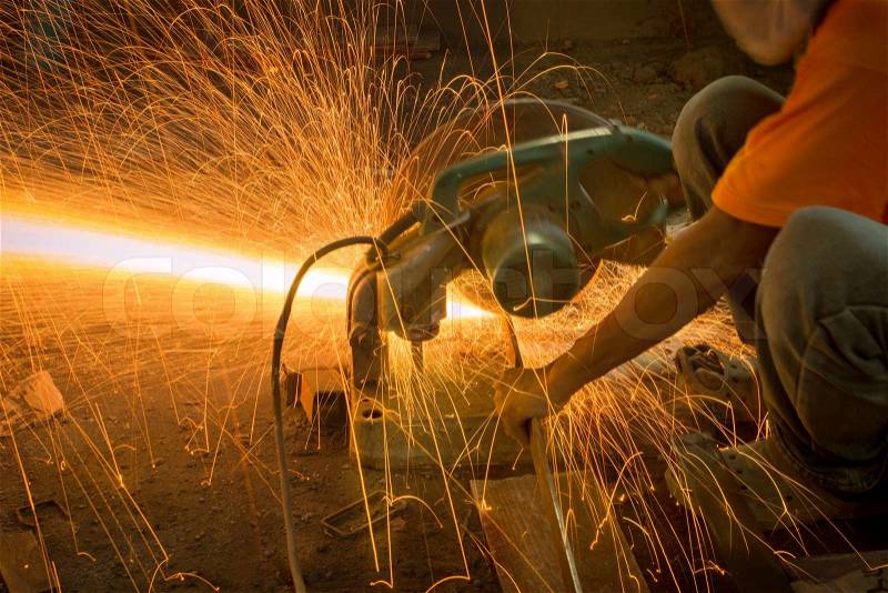 Man cutting and welding at work shop, stock photo