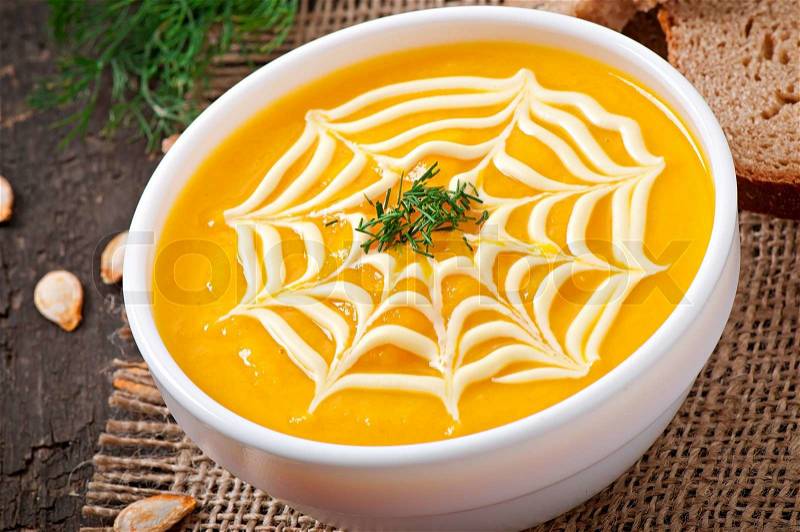 Cream of pumpkin soup with sour cream sauce, stock photo