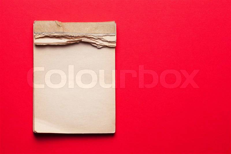Old notebook on red background , stock photo