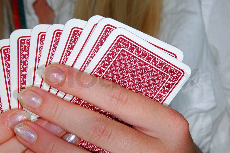 Girl with a deck of cards in her hand, stock photo