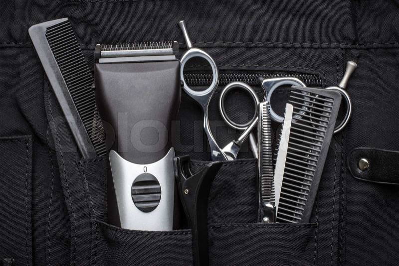 Professional tools of hairdresser in black case, stock photo