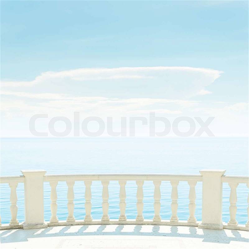 Balcony over sea and light clouds in blue sky, stock photo