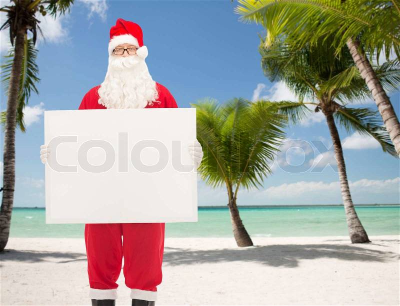 Christmas, holidays, advertisement and people concept - man in costume of santa claus with white blank billboard over tropical beach background, stock photo