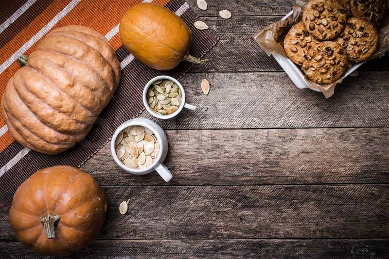 Rustic style pumpkins, seeds and cookies with nuts on table. Autumn Season food photo, stock photo