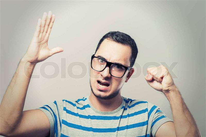 Frightened man defends himself with his hands, stock photo