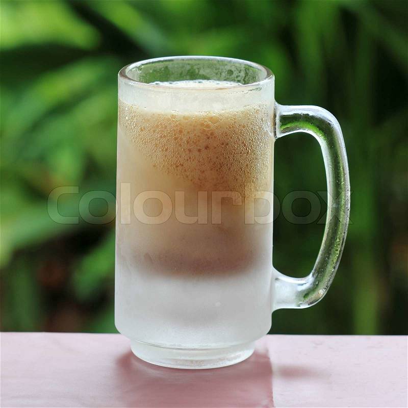 Old and cold Fashion mug of Root beer and foam, stock photo