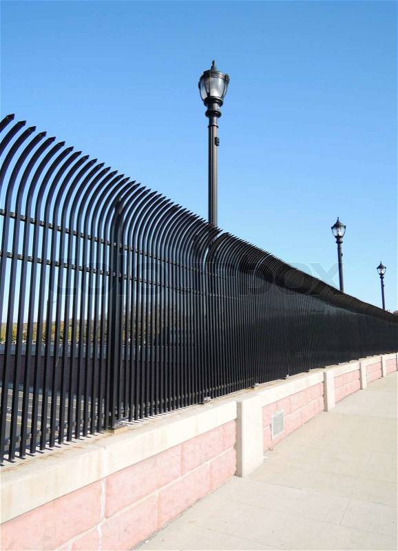 Street and a black steel fence, stock photo